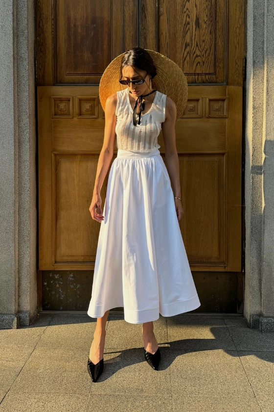 Спідниця-кльош міді з косими кишенями 