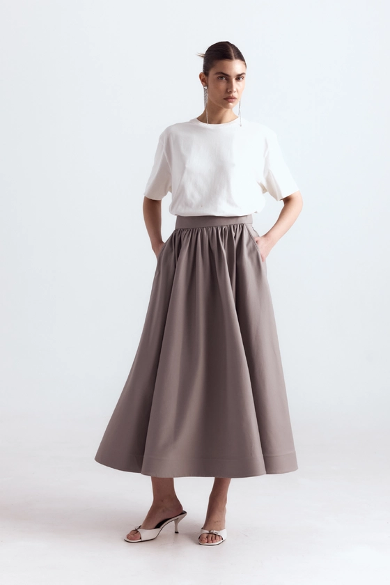 Спідниця-кльош міді з косими кишенями 